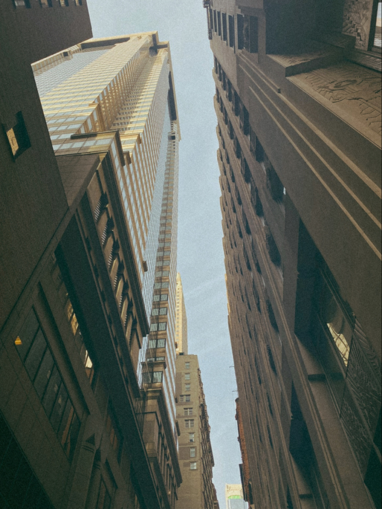 A view from the street looking up to skyscrapers overhead, in New York City.