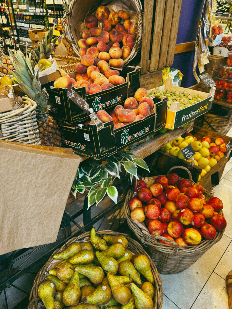 Fresh fruits in baskets in a local London grocery shop. 