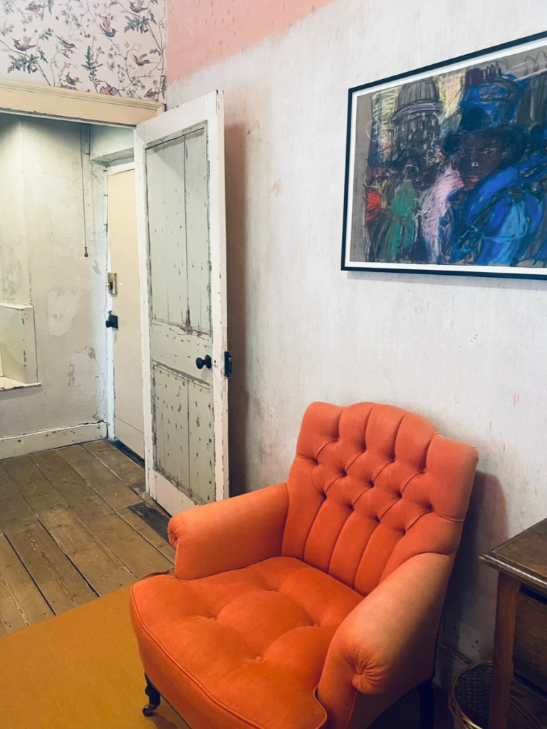 An orange plush chair to meditate on, in a bedroom in Durslade Farmhouse in Somerset.  